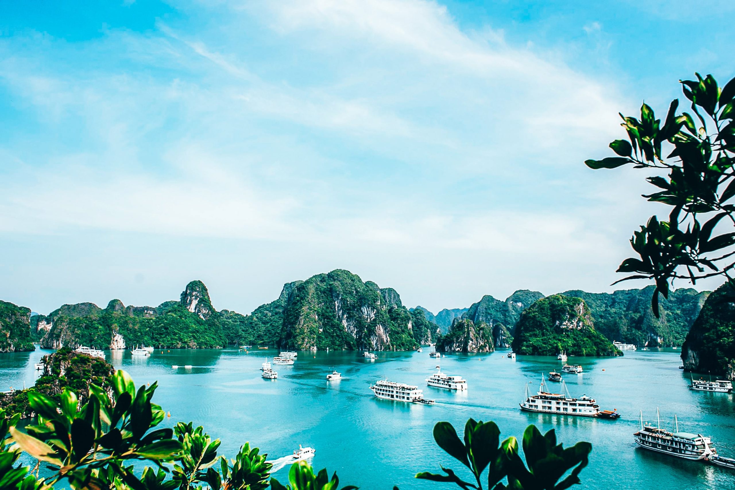 Scenic view of Ha Long Bay with cruise boats sailing through limestone islands, a must-visit destination near Hanoi, Vietnam.