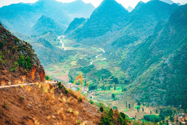 The BEST 3-day Ha Giang Loop Adventure: Winding mountain road through lush valleys and rugged peaks on the Ha Giang Loop in northern Vietnam.