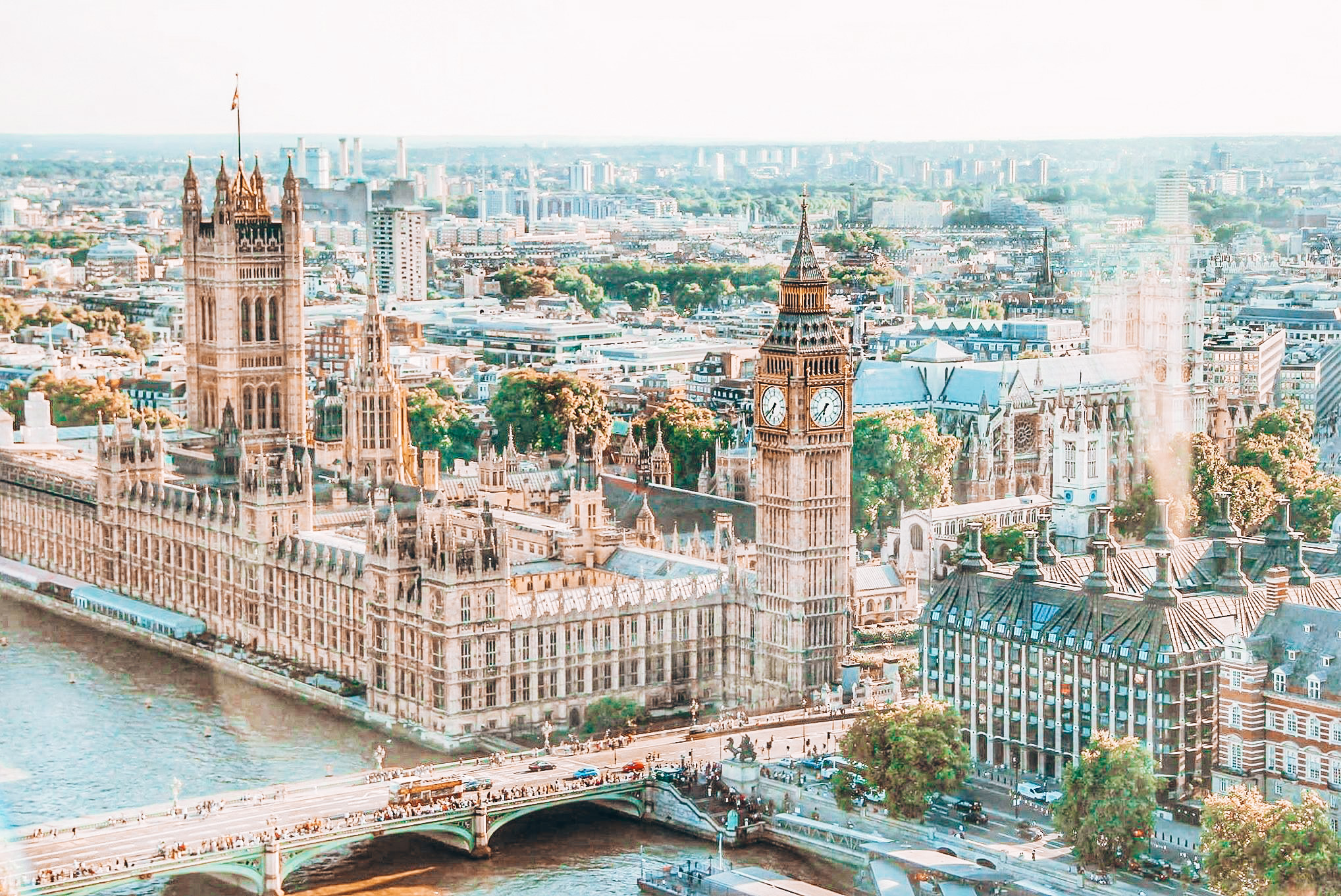 The best food spots in London: Aerial view of Big Ben and the Houses of Parliament in London, with the Thames River and Westminster Bridge below.