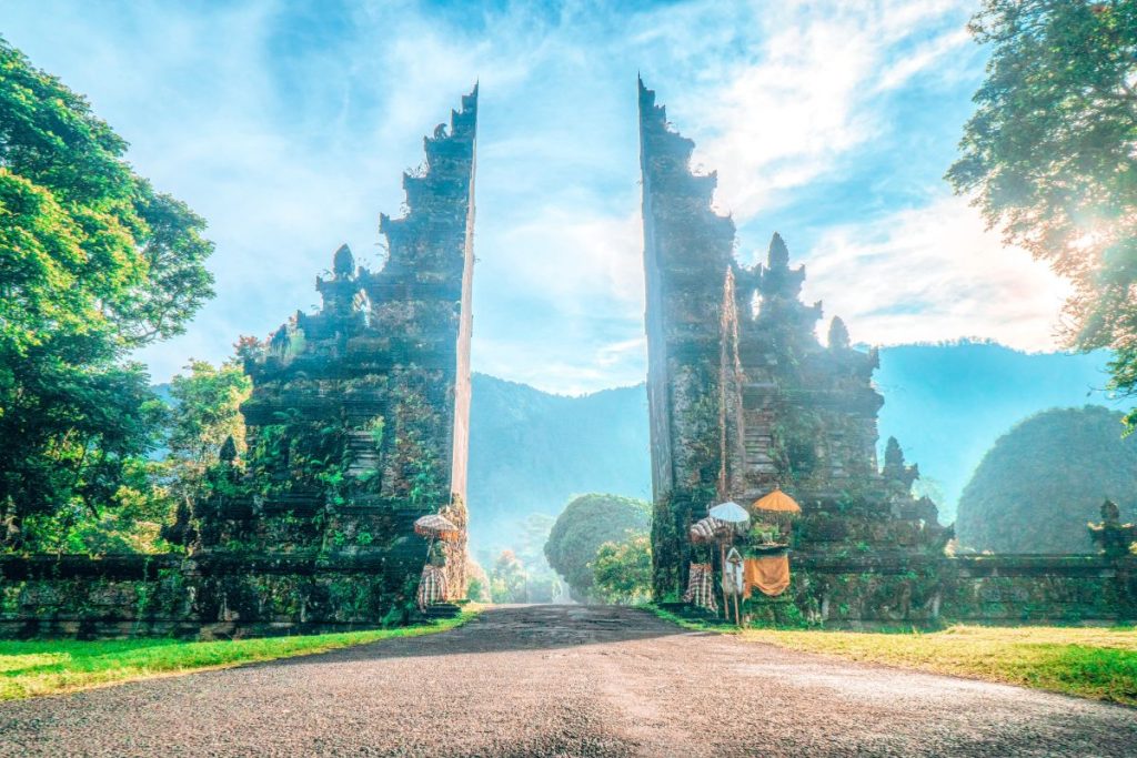 Important Things to Bring in Bali (Bali Packing List): The iconic split gate at Handara Gate in Bali, surrounded by lush greenery and morning light, is a must-visit spot to include in your Bali packing list for memorable photos and temple visits.