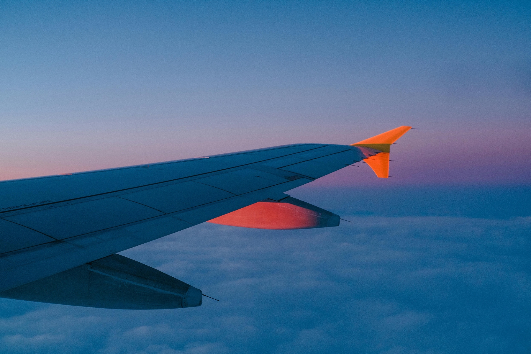 The Best Tips on How I Book Cheap Flights: plane during sunset.