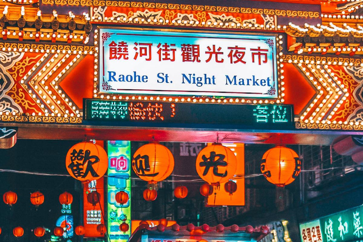 Best Food Spots in Taipei: View of Raohe St. Night Market Arch With Kanji Texts and Group of People