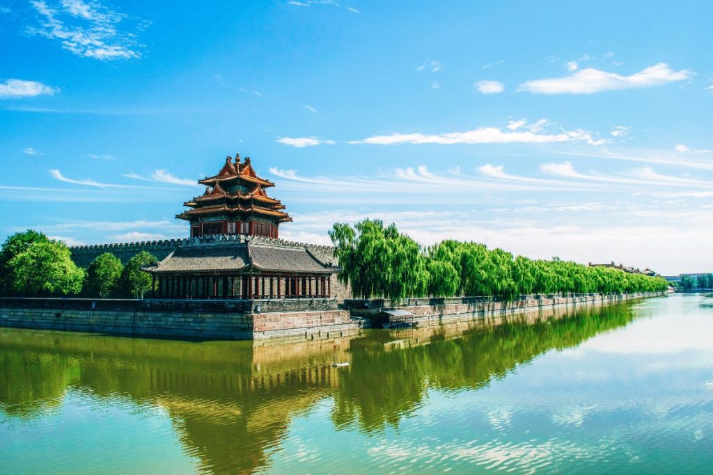 The Ultimate China Travel Guide Know Before You Go: Concrete Temple Near Body of Water Under Blue Sunny Sky